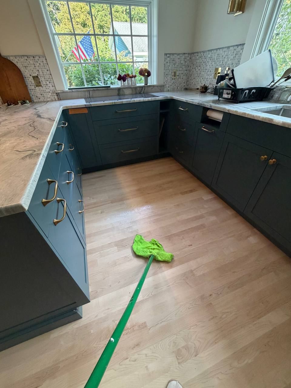 Hardwood kitchen floor being mopped