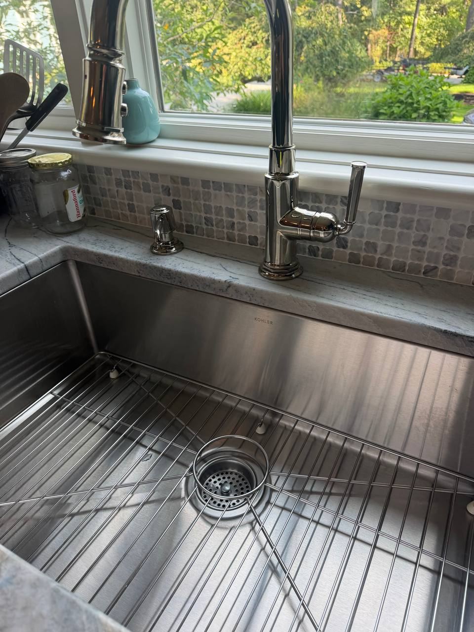 Polished stainless steel kitchen sink and faucet