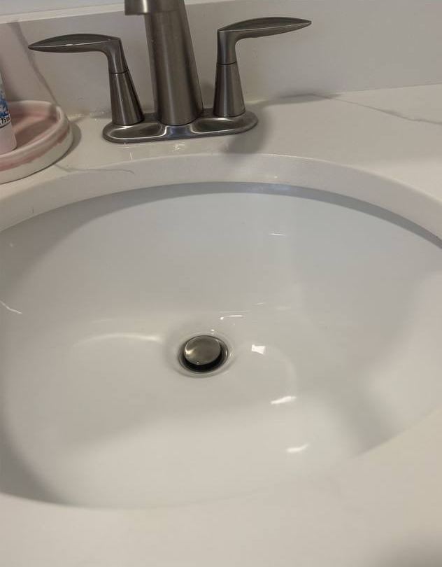 Bathroom sink after cleaning, spotless white basin